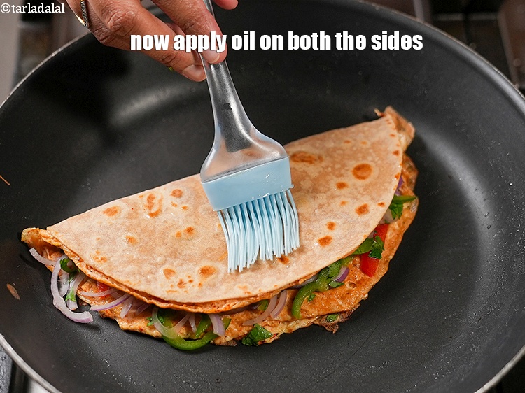 Step 22 – Now apply &frac12; tsp <a href="https://www.tarladalal.com/glossary-oil-671i">oil</a> on both the sides.