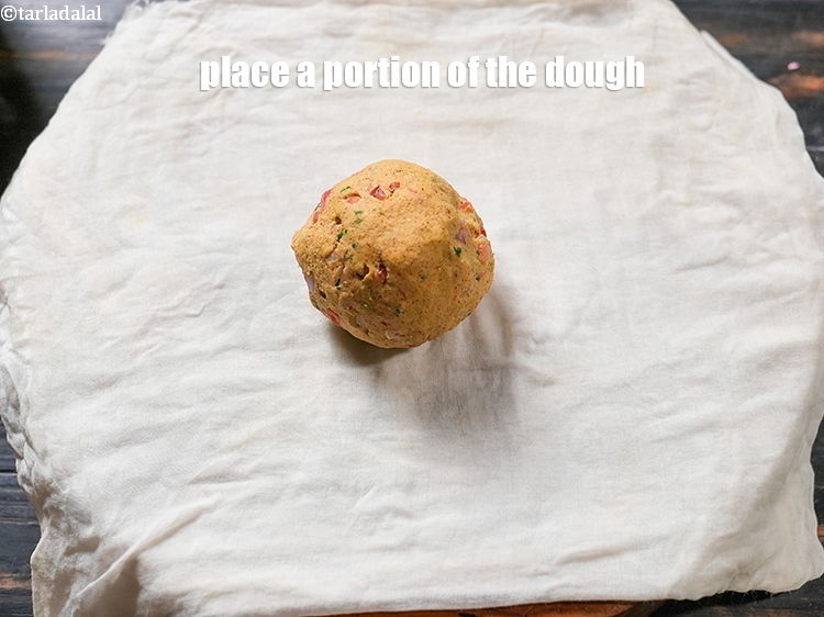 Step 23 – To make <strong>multiflour thalipeeth | healthy multigrain thalipeeth | quick mutliflour dhapate |&nbsp;</strong>place a portion …