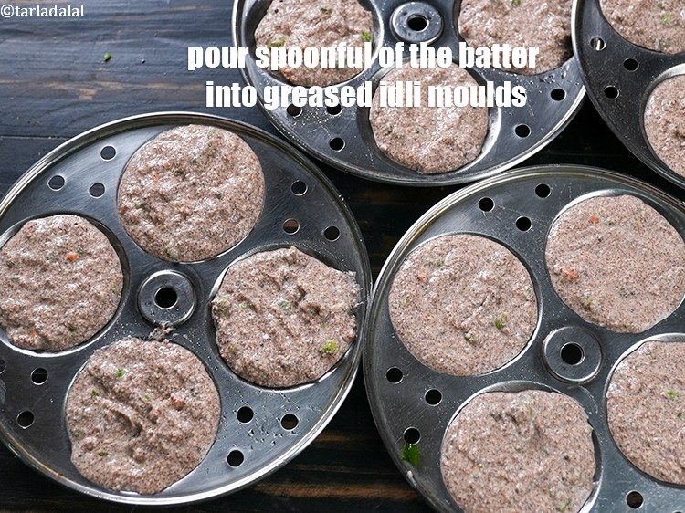 Step 23 – Pour spoonful of the batter into greased idli moulds.