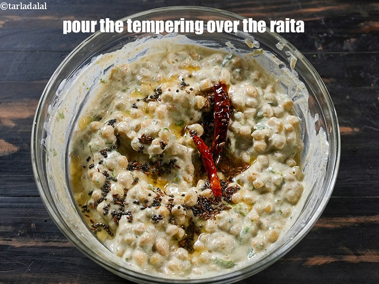 Step 24 – Switch off the flame and pour the tempering over the raita.