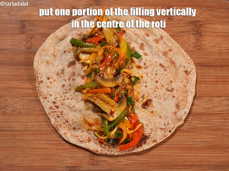 Step 22 – Put one portion of the filling vertically in the centre of the roti.