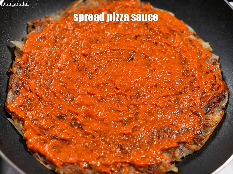 Step 22 – Spread 2 tbsp <a href="https://www.tarladalal.com/glossary-pizza-sauce-1889i">pizza sauce</a>.