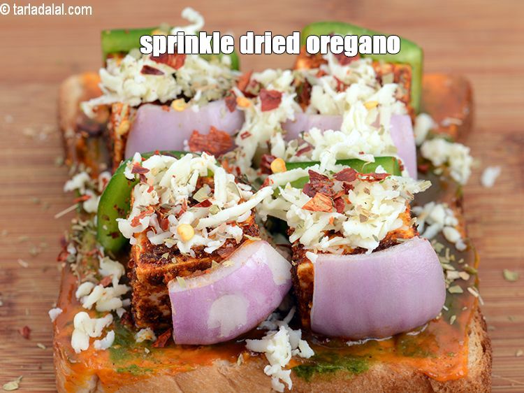 Step 22 – Sprinkle little <a href="https://www.tarladalal.com/glossary-dried-oregano-268i">dried oregano</a>.&nbsp;