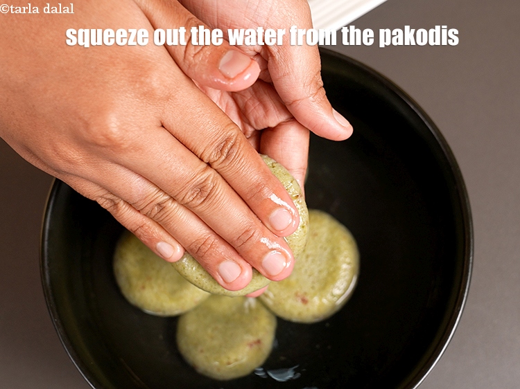 Step 22 – Then squeeze out the water from the pakodis and keep aside.