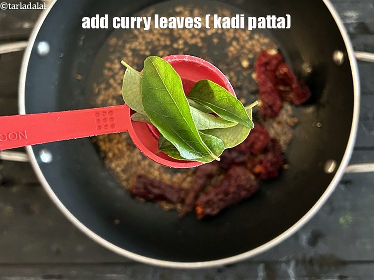 Step 22 – <html><head></head><body><p>Add&nbsp;5 to 6&nbsp;<a href="glossary-curry-leaves-kadi-patta-kadipatta-388i">curry leaves (kadi patta)</a>.</p></body></html>