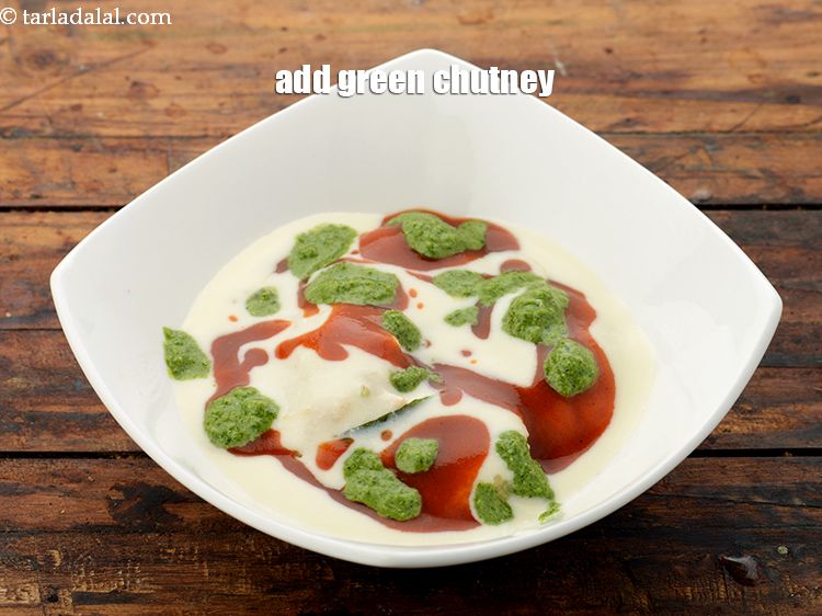 Step 54 – Put 2 tsp <a href="https://www.tarladalal.com/green-chutney-22266r" target="_blank">green chutney</a> evenly over it.