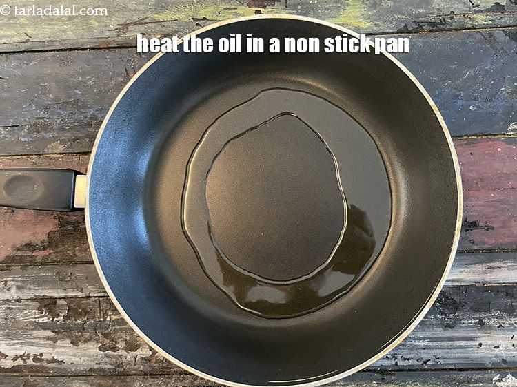 Step 22 – To make the Aloo Aur Shakarkand ki Chaat recipe, heat 3&nbsp;tbls oil in a broad …