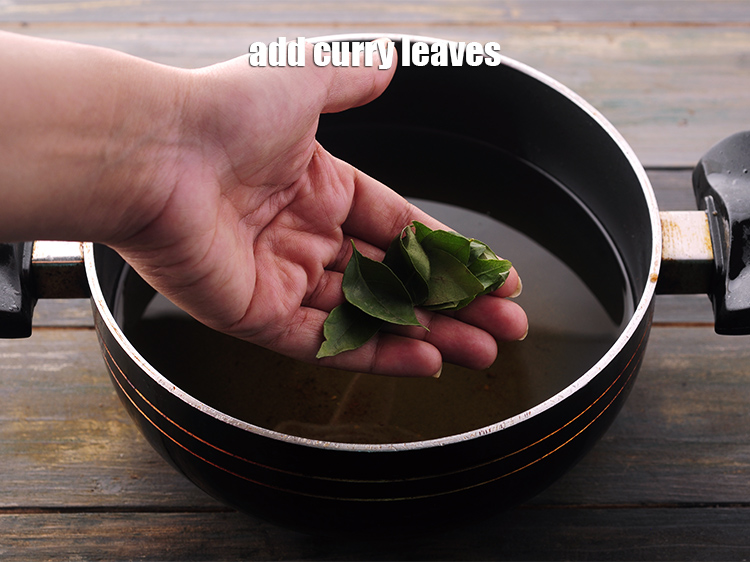 Step 24 – In the same hot oil, add the <a href="https://www.tarladalal.com/glossary-curry-leaves-kadi-patta-kadipatta-388i" target="_blank">curry leaves</a>.
