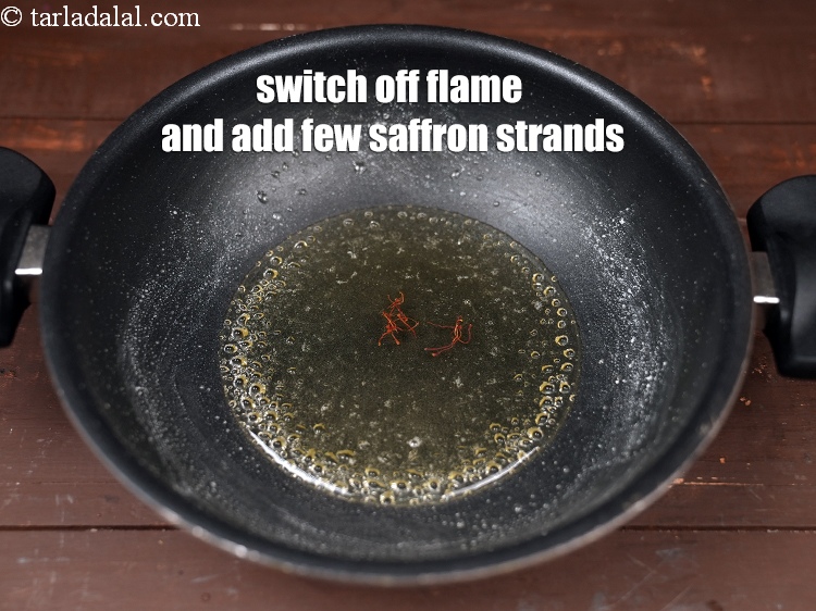 Step 23 – Switch off the flame and add few <a href="https://www.tarladalal.com/glossary-saffron-kesar-520i">saffron (kesar) strands</a>.