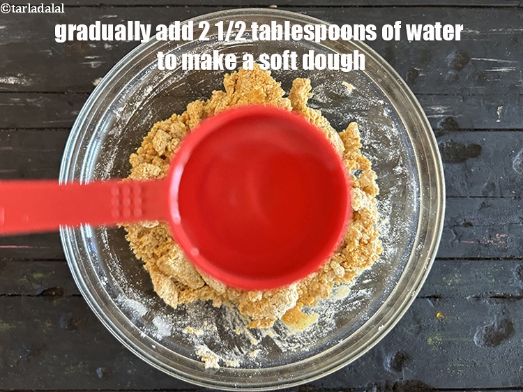 Step 22 – Gradually add 2 1/2 tablespoons&nbsp;of water to make a soft dough.