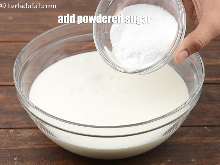 Step 22 – Add &frac14; cup <a href="https://www.tarladalal.com/glossary-powdered-sugar-280i">powdered sugar</a>.