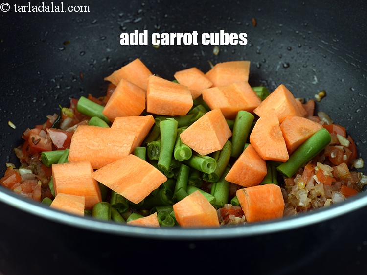 Step 23 – Add &frac12; cup <a href="https://www.tarladalal.com/glossary-carrot-cubes-730i">carrot cubes</a>.