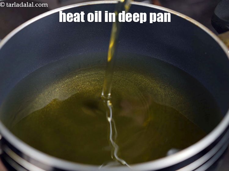 Step 21 – Heat the <a href="https://www.tarladalal.com/glossary-oil-671i">oil</a>&nbsp;in a deep non-stick pan.