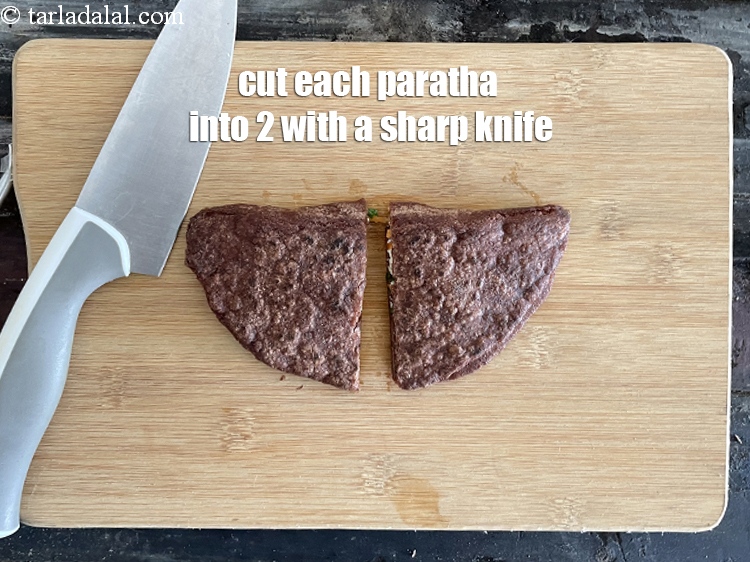 Step 27 – Cut each paratha into 2 using a sharp knife.