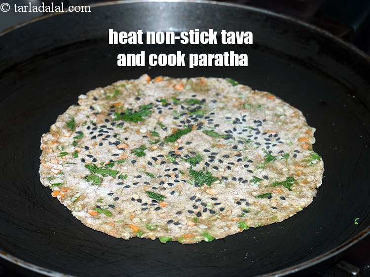 Step 22 – Heat a non-stick tava (griddle) and cook the paratha on medium flame.