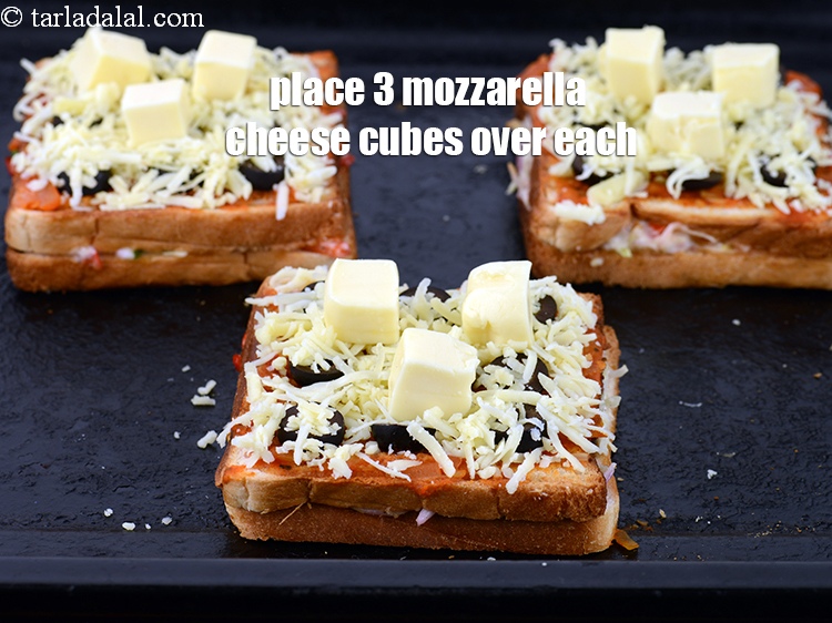 Step 22 – Place 3 <a href="https://www.tarladalal.com/glossary-mozzarella-cheese-cubes-1067i">mozzarella cheese cubes</a> over each sandwich.