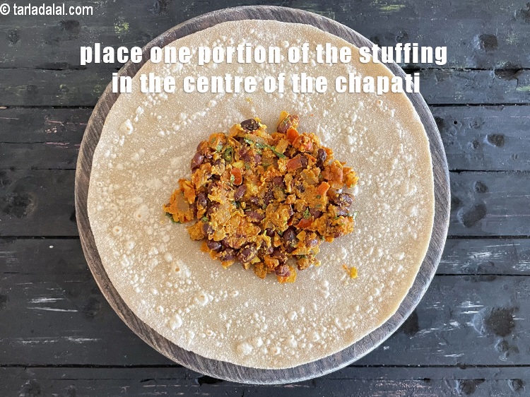 Step 42 – Spread one portion of the rajma filling in the centre of the chapati.