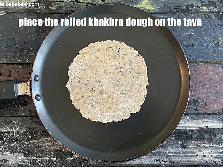 Step 23 – <meta charset="UTF-8" />Place the rolled out&nbsp;<strong>Khakhra</strong>&nbsp;dough on it.&nbsp;