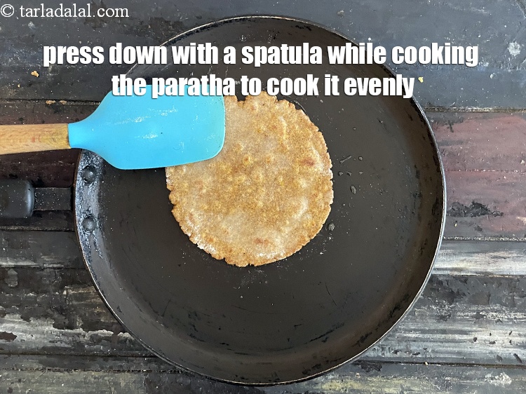Step 28 – Press down with a spatula while cooking the paratha so that it gets cooked uniformly.