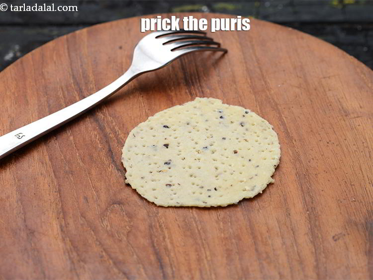 Step 24 – Prick the puris all over using a fork. This is done so the puris do …