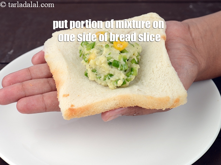 Step 22 – Put a portion of the mixture on one side of the bread slice.