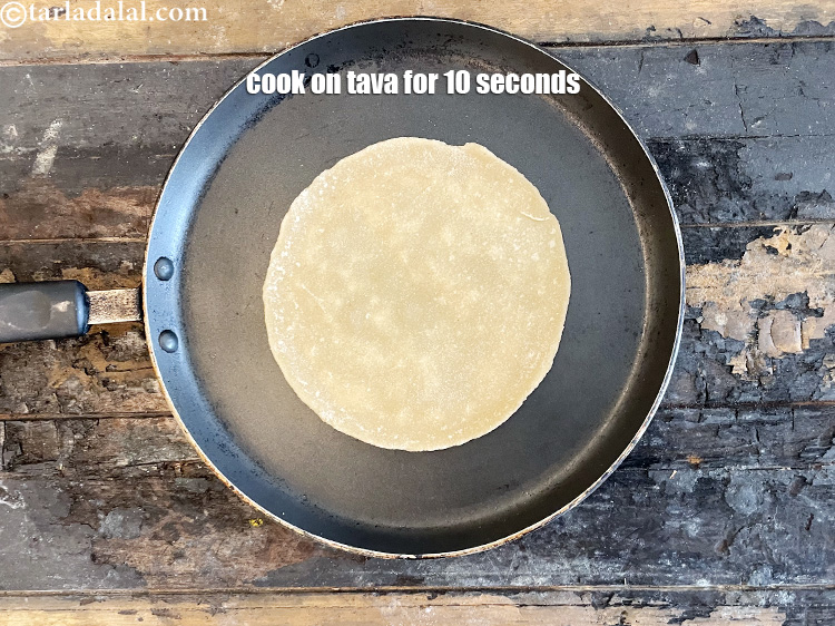 Step 23 – Cook for 10 &nbsp;seconds on high flame for each side to semi cook the roti.