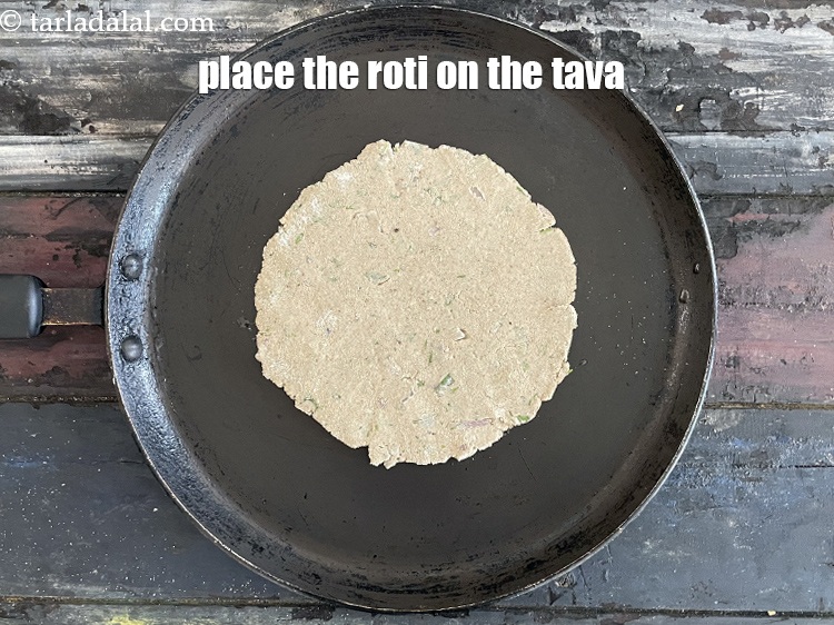 Step 22 – Place the roti gently on the tava. <u><em>NOTE that if you can&#39;t pick up the …