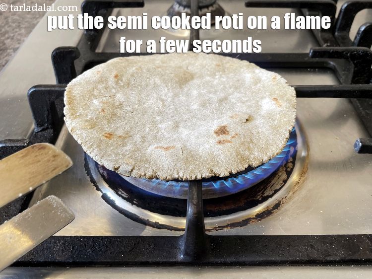 Step 25 – Put the semi cooked roti on the flame for a few seconds to cook it.