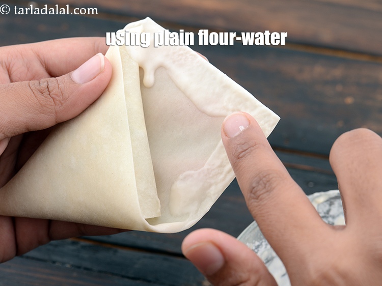Step 22 – Using the plain flour-water mixture so that the filling does not spill out.