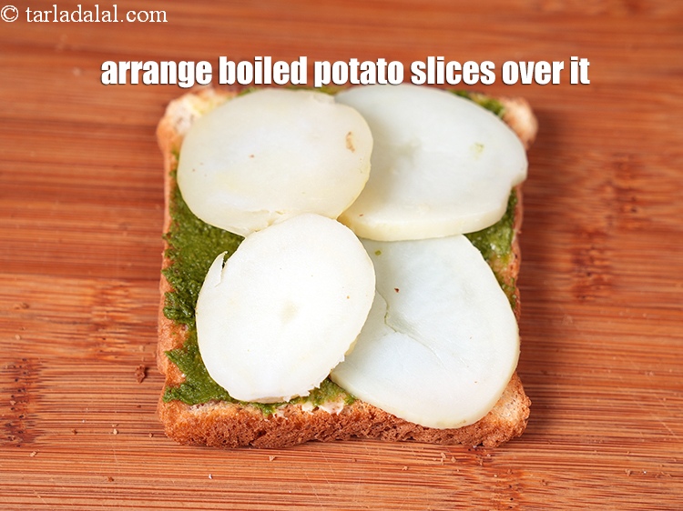Step 24 – Arrange 4 <a href="https://www.tarladalal.com/glossary-boiled-and-peeled-potato-slices-2223i">boiled potato slices</a> over it.