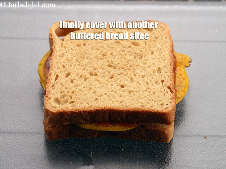 Step 22 – Finally cover with another buttered bread slice with the buttered side facing downwards.
