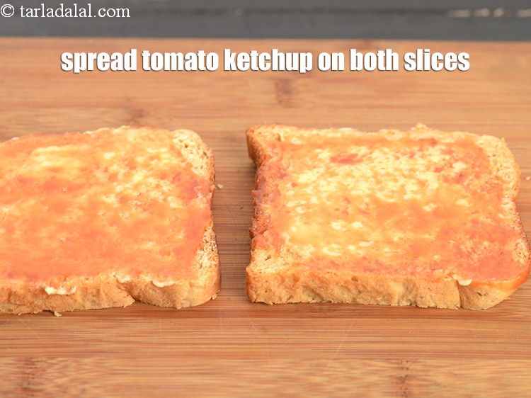 Step 23 – Spread &frac12; tsp of <a href="https://www.tarladalal.com/glossary-tomato-ketchup-tomato-sauce-181i">tomato ketchup</a> on both the buttered bread slices.