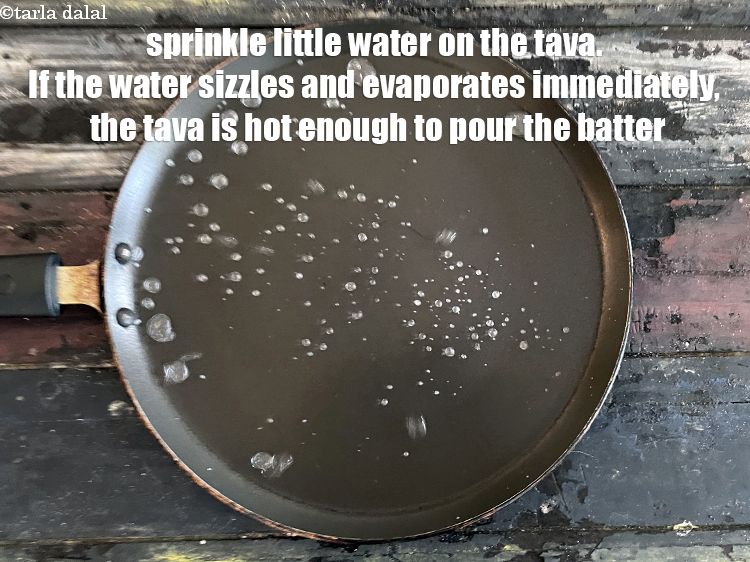 Step 22 – Sprinkle a little water on the tava (griddle). If the water sizzles and evaporates immediately, …
