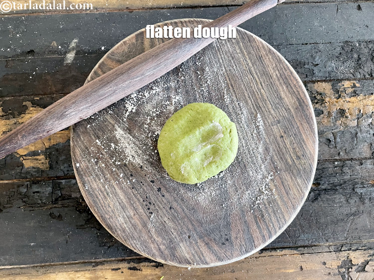 Step 41 – Take a portion of the dough and flatten it.