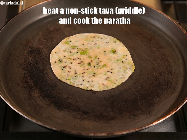 Step 24 – Heat a non-stick tava (griddle) and cook the paratha.