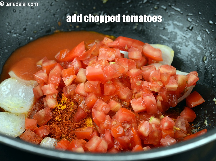 Step 24 – Add &frac12; cup <a href="https://www.tarladalal.com/glossary-chopped-tomatoes-779i">chopped tomatoes</a>.