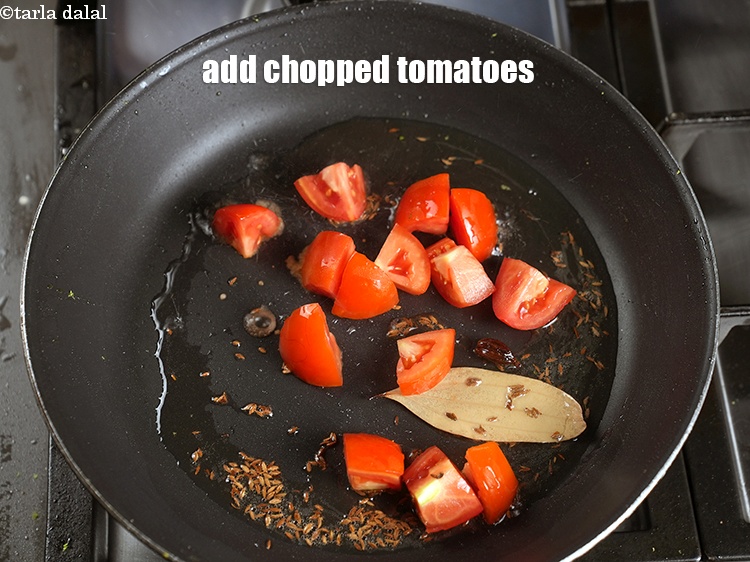 Step 23 – Add &frac12; cup roughly <a href="https://www.tarladalal.com/glossary-chopped-tomatoes-779i">chopped tomatoes</a>.