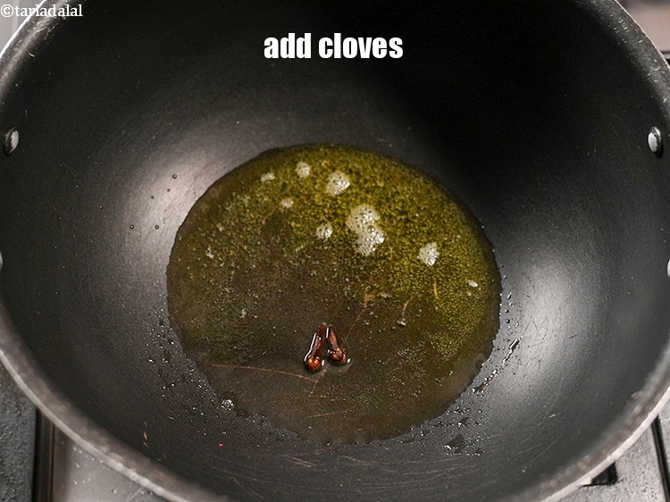 Step 24 – Add 2 <a href="https://www.tarladalal.com/glossary-cloves-laung-lavang-322i">cloves (laung / lavang)</a>.