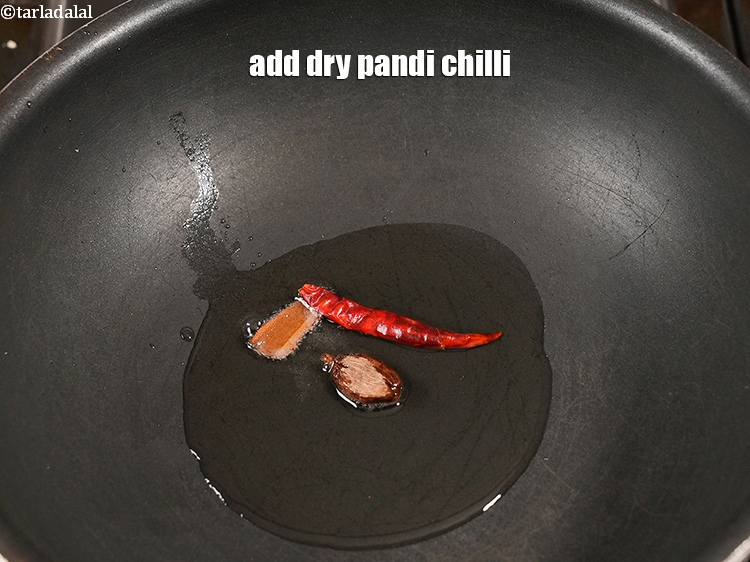 स्टेप 23 – १&nbsp;<a href=""https://www.tarladalal.com/glossary-pandi-chillies-pandi-dry-red-chillies-hindi-2373i"">सूखी पंडी मिर्च</a>&nbsp;डालें .