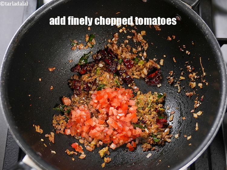 Step 23 – Add &frac14; cup finely <a href="https://www.tarladalal.com/glossary-chopped-tomatoes-779i">chopped tomatoes</a>.
