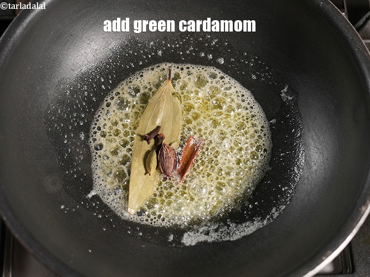 Step 24 – Add 1 green <a href="https://www.tarladalal.com/glossary-cardamom-elaichi-262i">cardamom (elaichi)</a>.