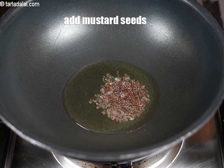 Step 23 – Add &frac12; tsp <a href="https://www.tarladalal.com/glossary-mustard-seeds-sarson-rai-sarson-ke-beej-525i">mustard seeds ( rai / sarson)</a>.