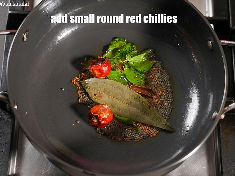 Step 23 – Add 2 small&nbsp;<a href="https://www.tarladalal.com/glossary-round-red-chillies-boriya-chilli-boria-mirch-1096i">round red chillies (boriya mirch)</a>&nbsp;