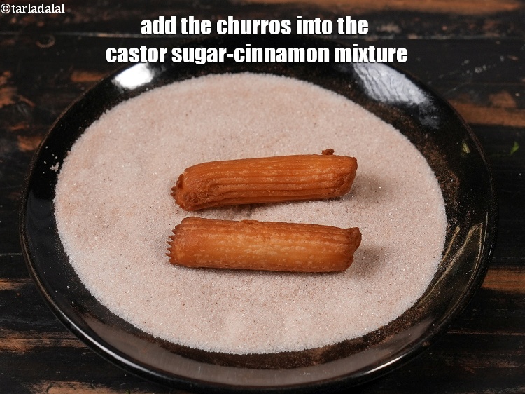 Step 24 – Add the churros into the castor sugar-cinnamon mixture.