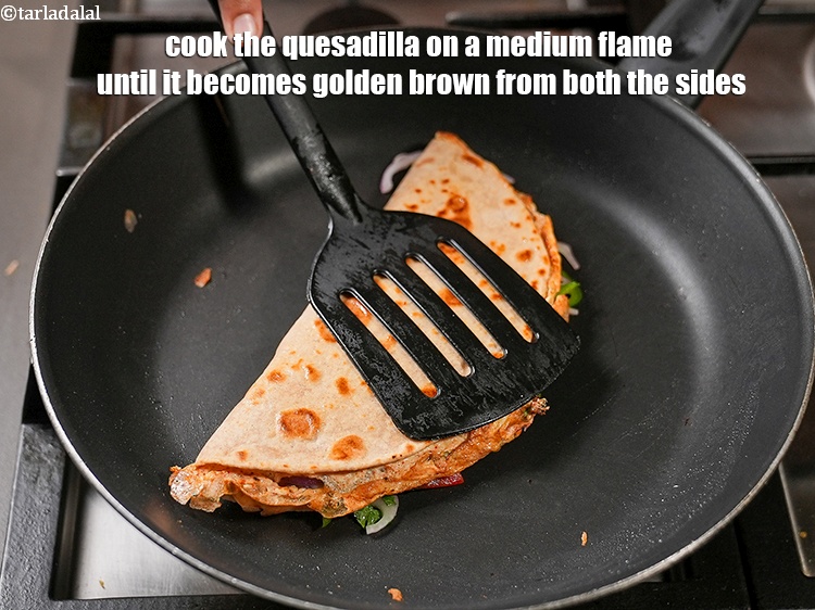Step 23 – Cook the quesadilla on a medium flame until it becomes golden brown from both the …