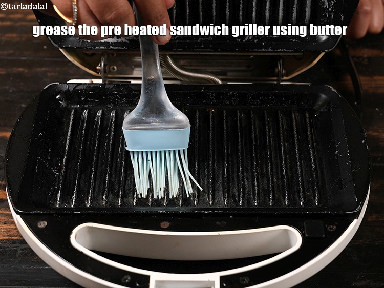 Step 23 – Grease the pre heated sandwich griller using 1 tsp butter.&nbsp;