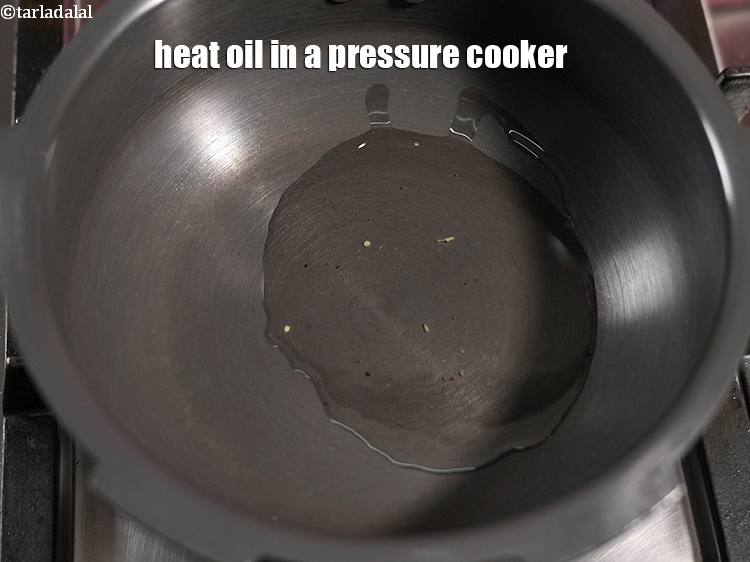 Step 23 – Heat 2 tbsp oil in a pressure cooker.