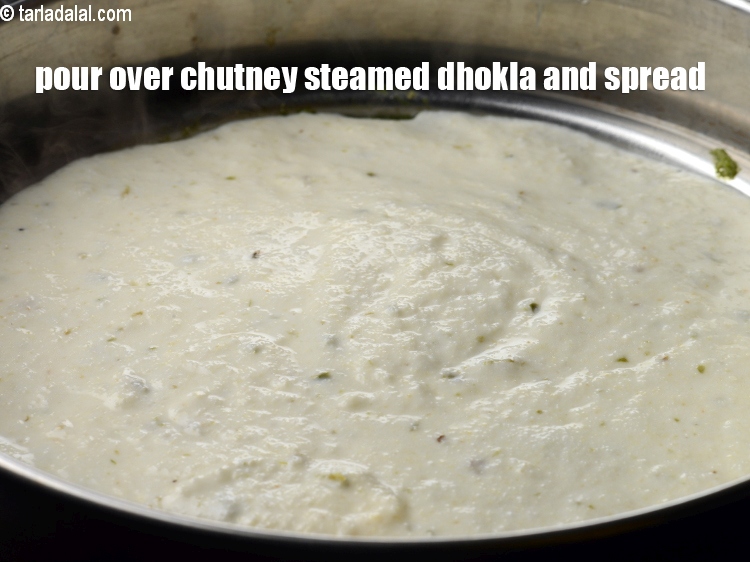 Step 24 – Pour over the chutney mixed steamed dhokla and spread it evenly.