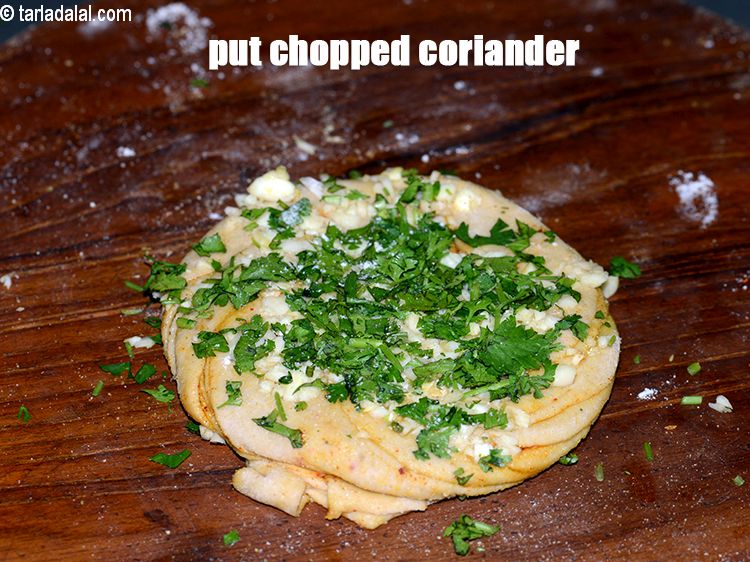 Step 23 – Put 1 tbsp finely <a href="https://www.tarladalal.com/glossary-chopped-coriander-783i">chopped coriander (dhania)</a> on the swiss roll.