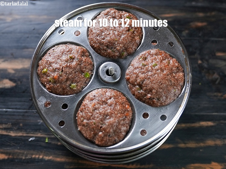 Step 24 – Steam in an idli steamer for 10 to 12 minutes or till they are cooked.